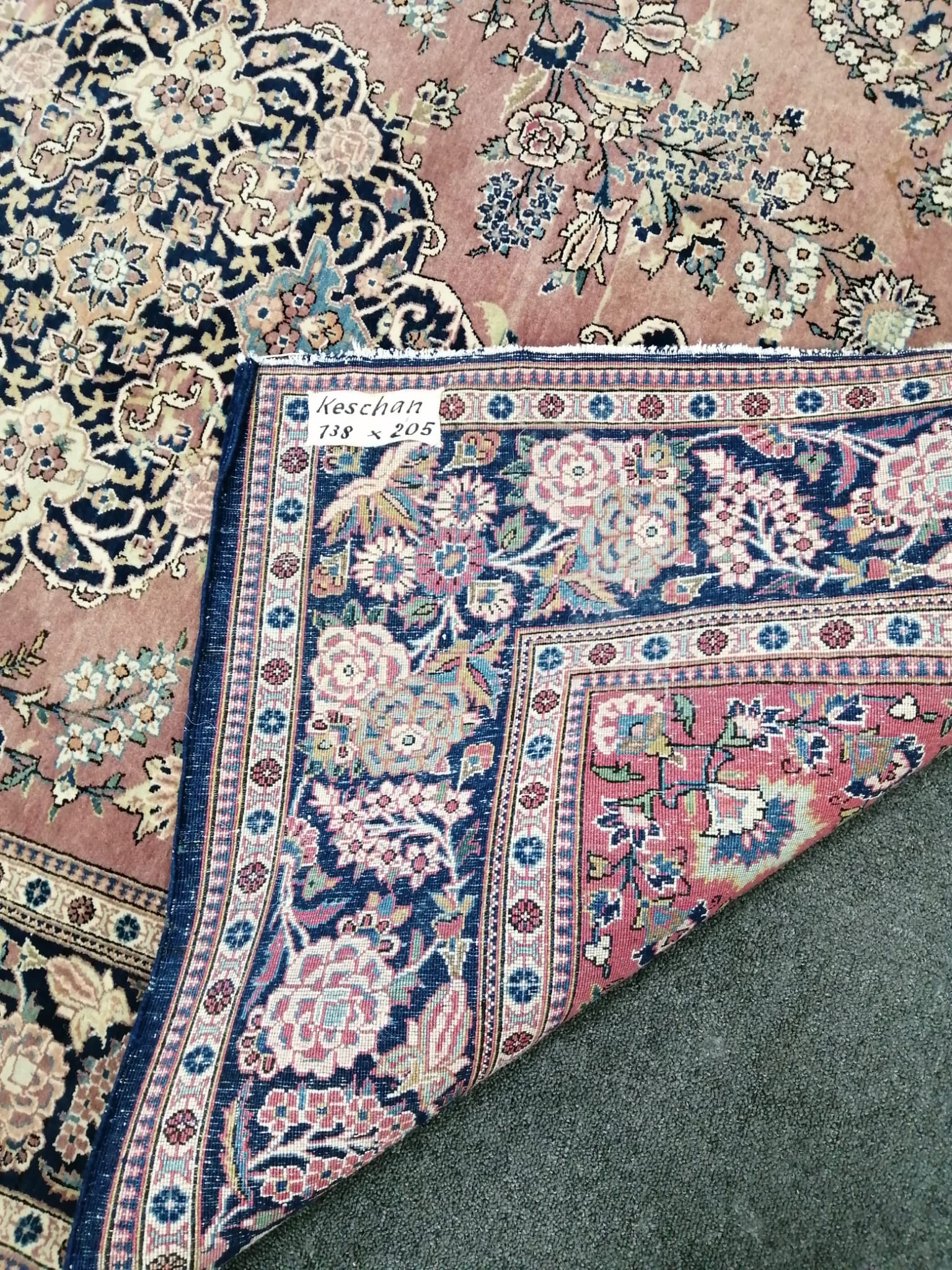 A Kashan mauve ground rug, 202 x 133cm